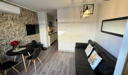 a living room with a couch and a table and chairs at A ESTRENAR PRECIOSOS APARTAMENTOS APARTHOTEL INTER2, NEW APARTMENTS lN APARTHOTEL 12 months open! self check in! RESERVA Garaje! in Salou