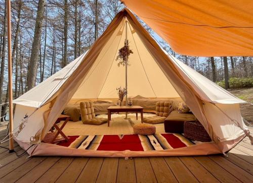 a tent with a couch and a table on a deck at Nagano Forest Village "former name: Iizuna Kogen C - Vacation STAY 42158v 