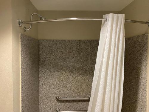 a shower with a shower curtain in a bathroom at Best Western Plus Graham Inn in Graham