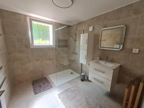 a bathroom with a shower and a sink and a mirror at Appartement Vacances ZEN in Fréjus