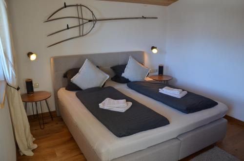 a bedroom with a bed with two pillows on it at Bergbauernhof Obergaisberg in Kirchberg in Tirol