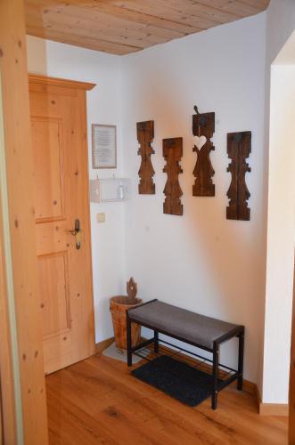 a room with a bench on a wall with wooden ceilings at Bergbauernhof Obergaisberg in Kirchberg in Tirol