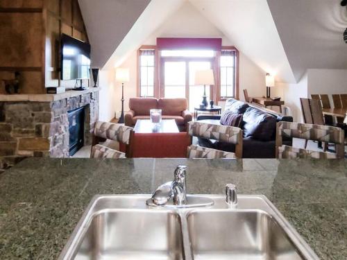 a kitchen with a sink and a living room at Hyatt Residence Club Main Street Station in Breckenridge