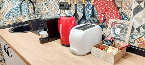 a kitchen counter with a toaster and other appliances on it at Azulejo Apartment in Novi Beograd