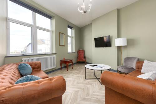 a living room with two couches and a tv at GiGi's in Blackpool