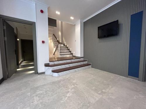 a hallway with stairs and a tv on a wall at Pendik Marine Hotel in Istanbul