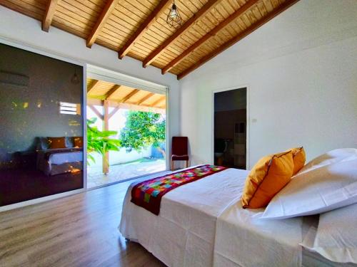 a bedroom with a large bed and a fireplace at Villa BABYLAS in Sainte-Anne