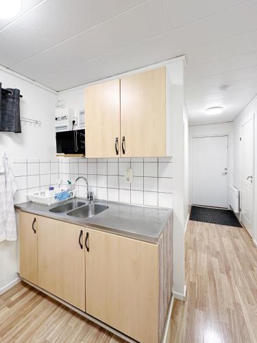 a kitchen with a sink and a counter top at Ystad Holiday Houses in Ystad