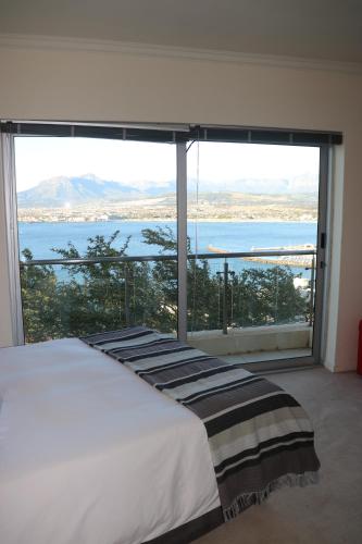 a bedroom with a large view of the water at C'est la vie, and a view. in Cape Town