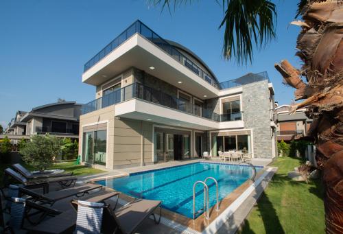 an exterior view of a house with a swimming pool at Living Dream Villa RELAX in Belek