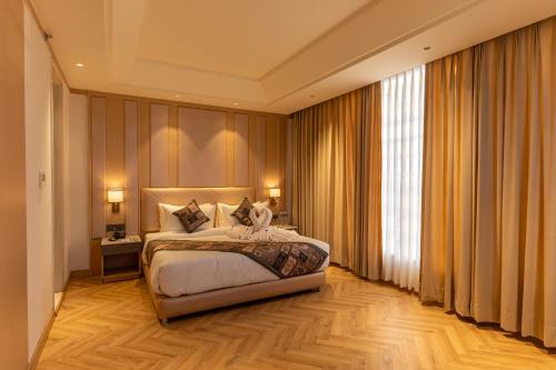 a bedroom with a bed and a large window at Sandoz Amritsar - Lawrence Road in Amritsar