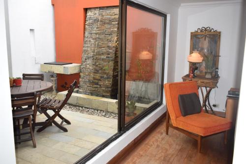 a room with a glass window with a table and chairs at Casa Pabón in Bogotá