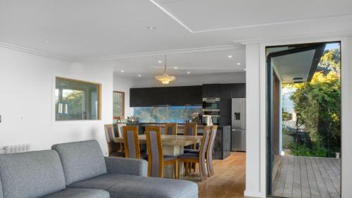 a dining room and kitchen with a table and chairs at Sunset Haven in Nelson in Nelson