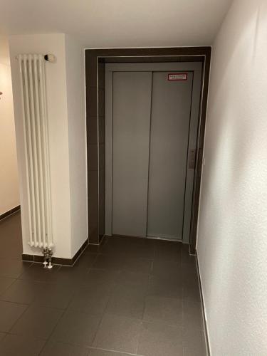 a hallway with a door in a building at Hotel Merkenich in Cologne