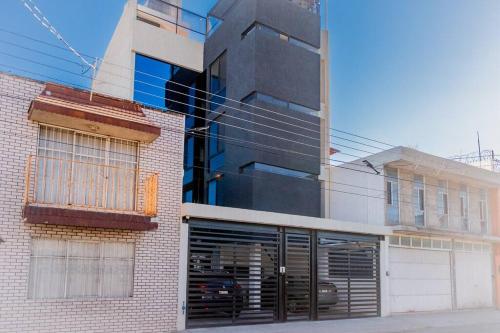 a brick building with a garage in front of it at New York Loft en Centro Historico con Roof Garden in Durango