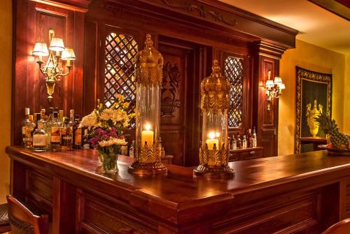 a bar with candles on top of a wooden table at Hotel Doupiani House in Kalabaka