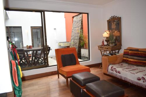 a living room with a chair and a window at Casa Pabón in Bogotá