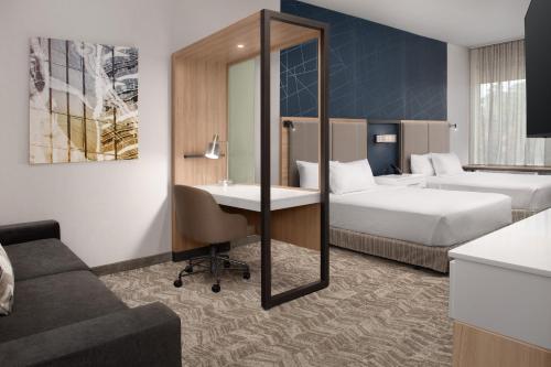 a hotel room with two beds and a desk at SpringHill Suites by Marriott Fayetteville I-95 in Fayetteville