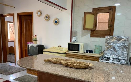 a kitchen with a counter top with a microwave at شقة فندقية علويه بجوار البحر in Sharm El Sheikh