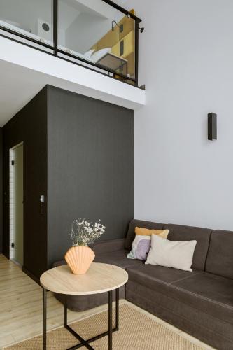 a living room with a couch and a table at Hotel Saltic Resort & Spa Grzybowo in Kołobrzeg