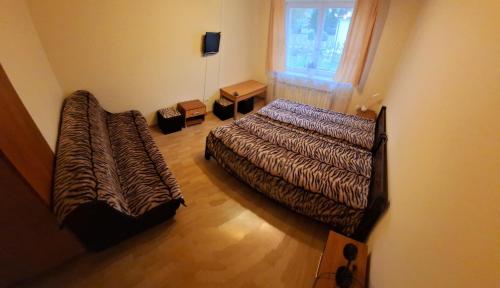 a bedroom with a large bed and a window at Sen na Roztoczu in Szczebrzeszyn