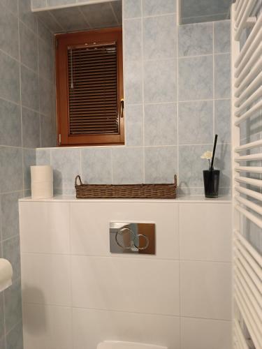 a bathroom with a toilet and a window at 3 bathrooms Apartman Mimi in Liptovský Mikuláš