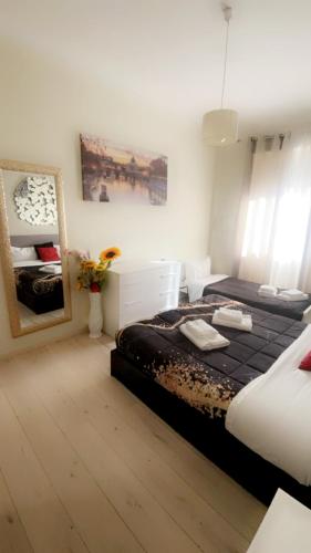 a bedroom with a large bed and a mirror at Vatican Sofia house in Rome