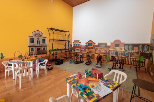 a room with a play room with tables and chairs at ibis Styles Presidente Prudente Portal D'Oeste in Presidente Prudente