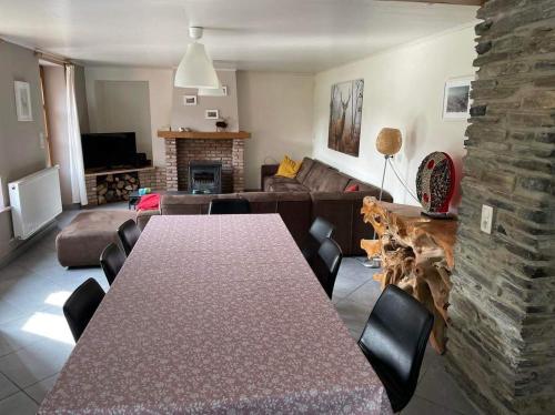a living room with a table and a couch at l'oiseau d'eau in Bouillon