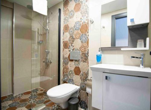 a bathroom with a toilet and a shower and a sink at Sea view room with Balcony,in middle of AyaSofia in Istanbul