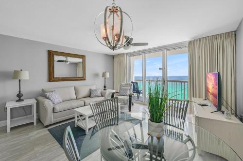 a living room with a couch and a table at Pelican Beach Resort by Tufan in Destin