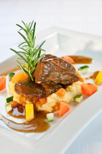 a plate of food with meat and vegetables and gravy at Hotel Donauhof in Emmersdorf an der Donau