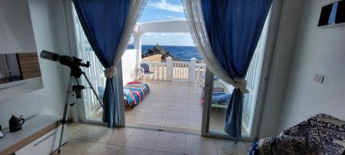 コスタ・デル・シレンチオにあるSEA VIEW in Silent Residence South TENERIFEのガラスドア付きの客室から海の景色を望めます。