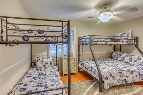 a bedroom with two bunk beds and a ceiling fan at Myrtle Beach Home with Saltwater Pool, Walk to Beach in Myrtle Beach