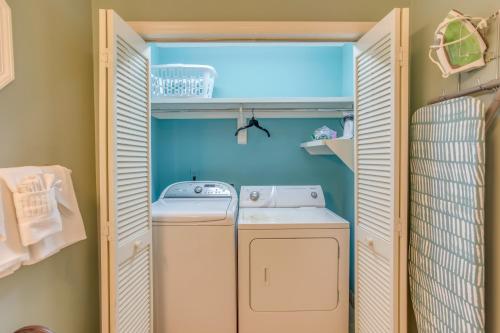 a washer and dryer in a small laundry room at Myrtle Beach Home with Saltwater Pool, Walk to Beach in Myrtle Beach