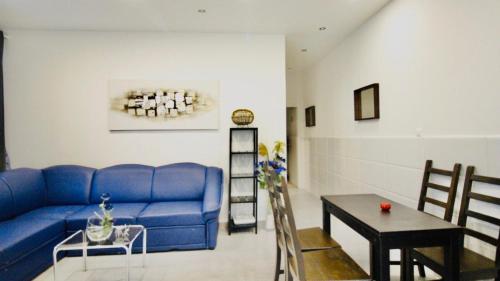 a living room with a blue couch and a table at Luxury Apartment in Praterstern area in Vienna