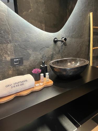 a bathroom with a bowl sink on a counter at Gray Apartments in Strumica