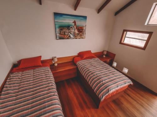 a room with two beds in a room at Ecolodge Santo Campo in Isla de Sol