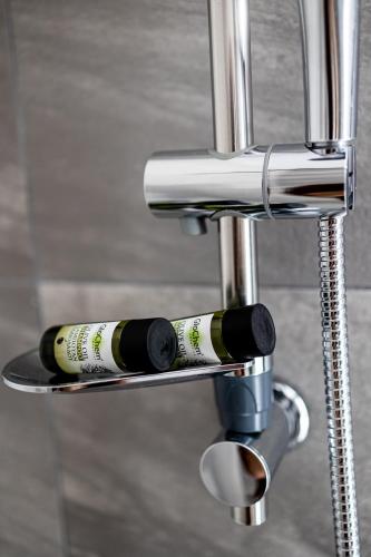 two wine bottles on a metal bar stool at Pagani Green - Luxury Studio A2 in Kalamata