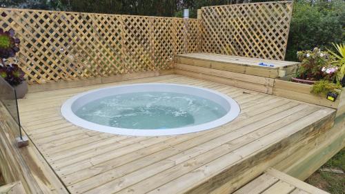 a hot tub sitting on a wooden deck at Lily Home in Algarrobo