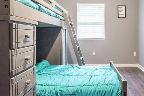 a bedroom with a bunk bed with a ladder at Quiet Cozy 3bedroom home 10 minutes from Downtown in New Orleans