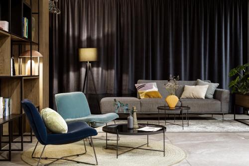 a living room with a couch and chairs and a table at Hotel Saltic Resort & Spa Grzybowo in Kołobrzeg