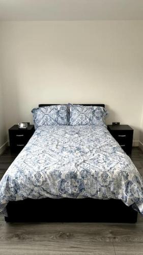 a bedroom with a bed and two night stands at Brand New 3 bedroom House in Gated Development! in Polesworth