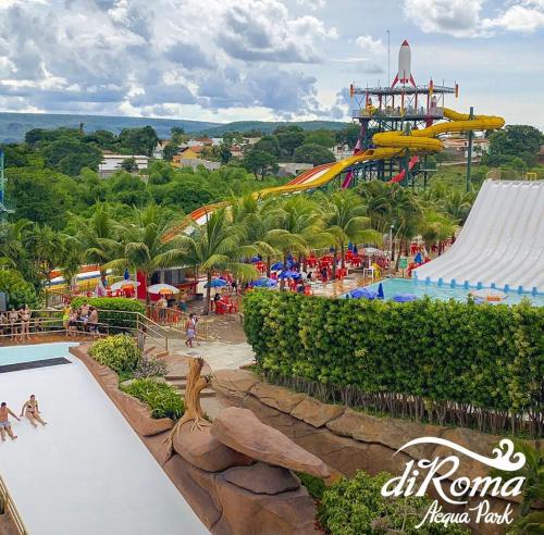 an amusement park with a roller coaster in the background at Spazzio Diroma Acqua Park Luxo in Caldas Novas