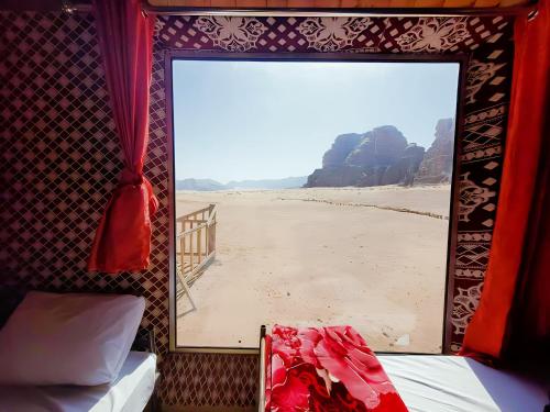 a room with a window with a view of the beach at Rest luxury camp in Disah