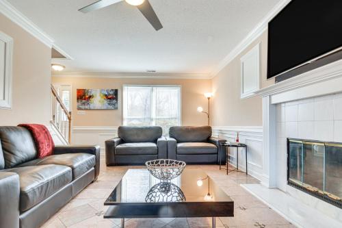 a living room with a couch and a fireplace at Raleigh Home Near Dining and Shops! in Raleigh