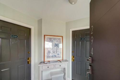 a hallway with two doors and a picture on the wall at 294 Moss Oak Circle in Saint Simons Island