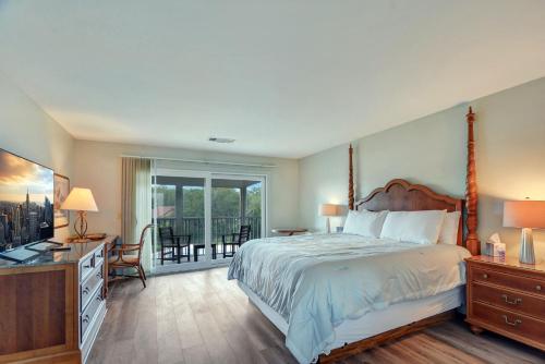 a bedroom with a large bed and a balcony at 294 Moss Oak Circle in Saint Simons Island