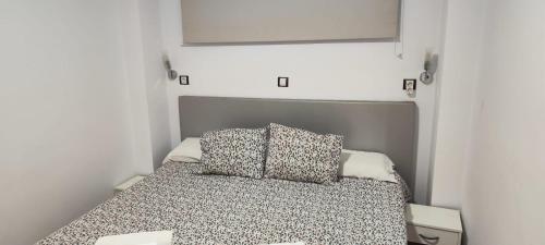 a bedroom with a bed with two pillows on it at 5 min walk from Yumbo 310 in Playa del Ingles