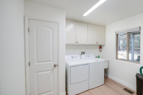 a white kitchen with a washer and dryer at Serene Pine Mountain Club Home with Pool Access! in Pine Mountain Club